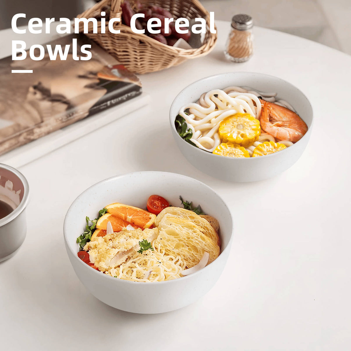 Two white speckled ceramic bowls on white table filled with udon soup and mixed rice bowl