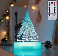 LED Christmas tree lamp with gift designs and 'Merry Christmas' text, glowing blue with remote control