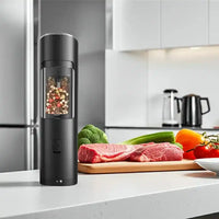 Electric salt and pepper grinder placed on kitchen table with ingredients nearby