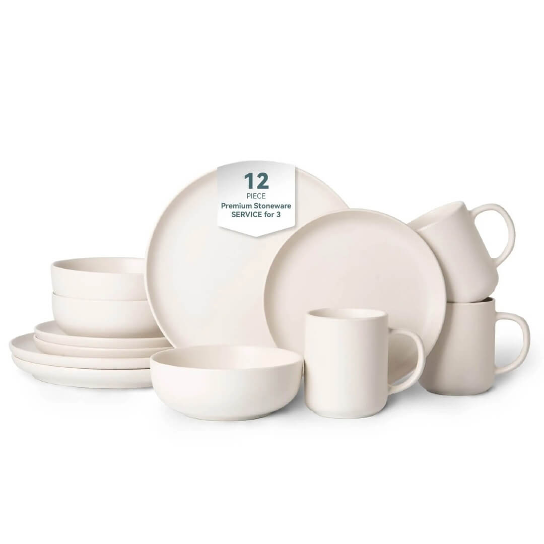 Complete 12-piece off-white matte stoneware set including dinner plates, salad plates, cereal bowls and mugs arranged on white background