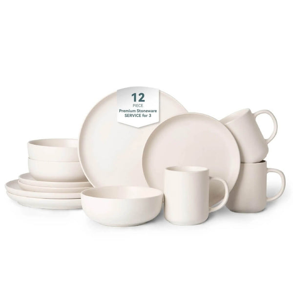 Complete 12-piece off-white matte stoneware set including dinner plates, salad plates, cereal bowls and mugs arranged on white background