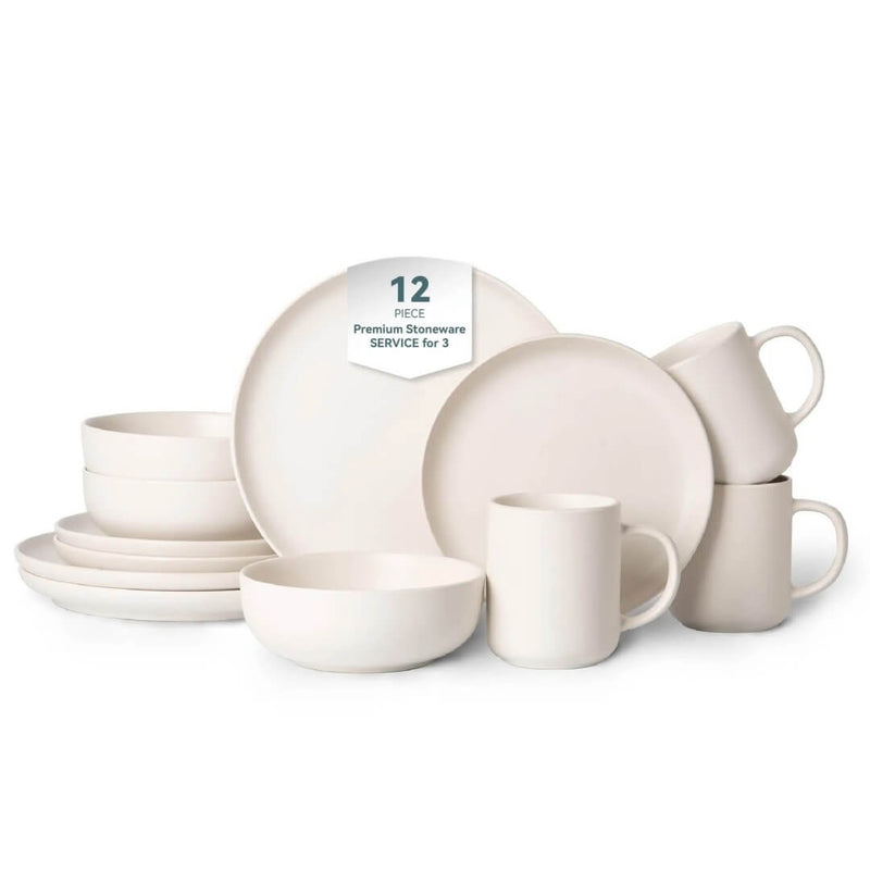 Complete 12-piece off-white matte stoneware set including dinner plates, salad plates, cereal bowls and mugs arranged on white background