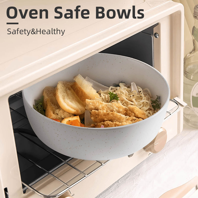 Light blue speckled ceramic bowl filled with noodles and fried food inside open cream toaster oven
