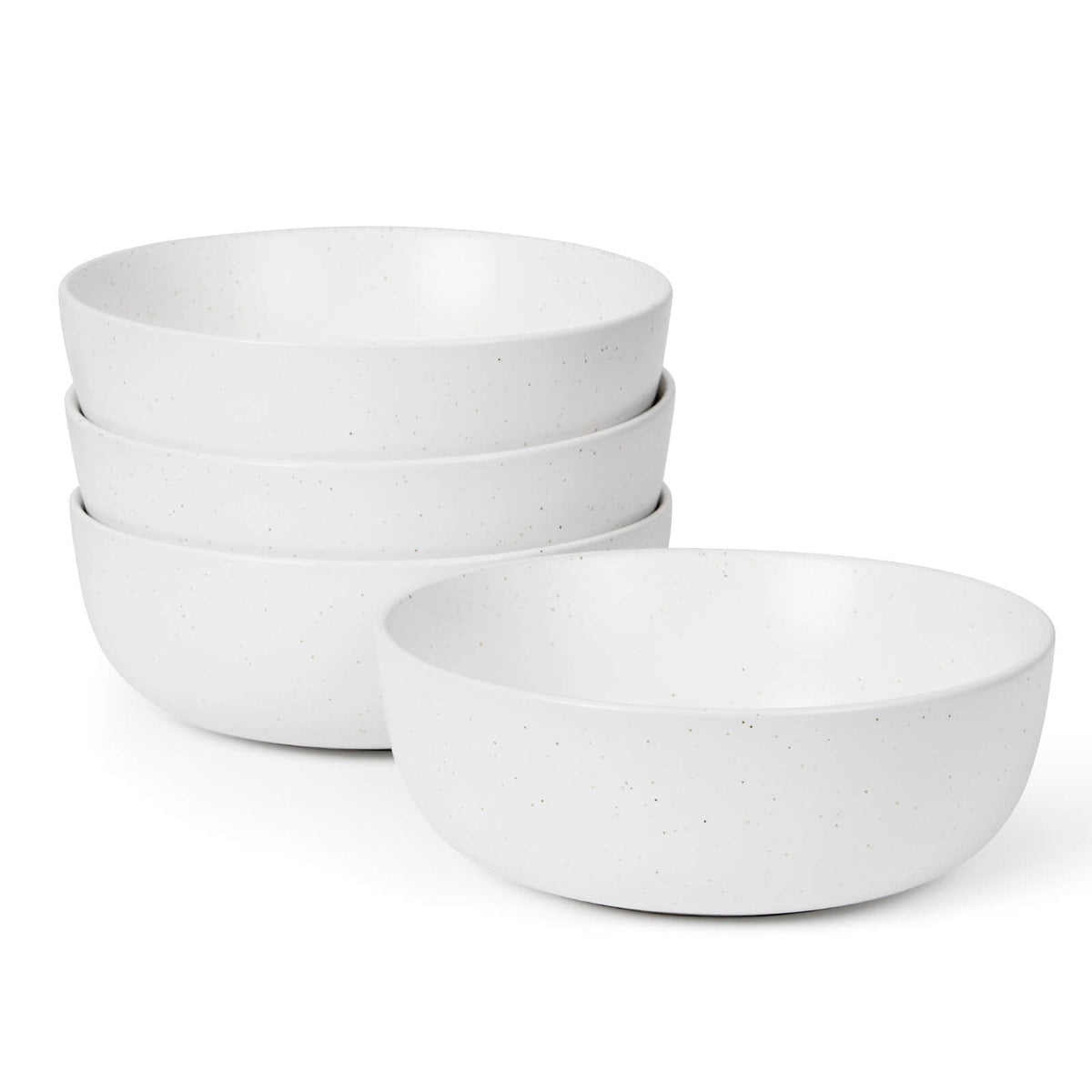 Four white speckled matte ceramic bowls stacked on white background, one bowl placed separately in front