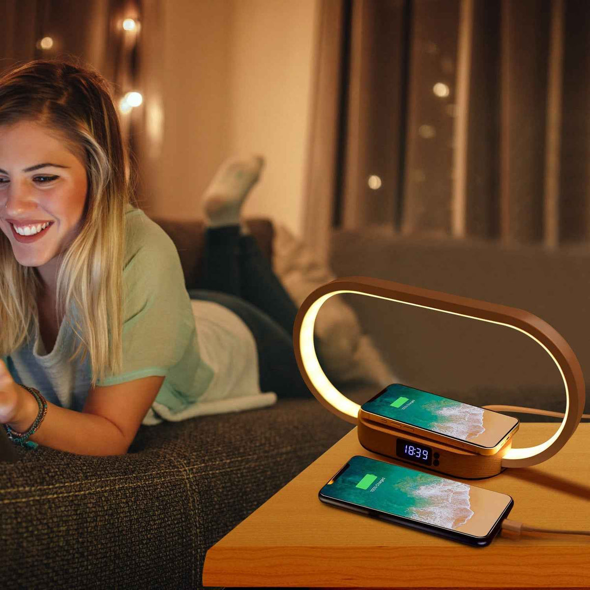 Woman relaxing on bed beside minimalist wooden bedside lamp with wireless charging station and digital clock on nightstand