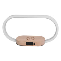 White minimalist bedside touch lamp with wooden wireless charging base and digital clock display on white background