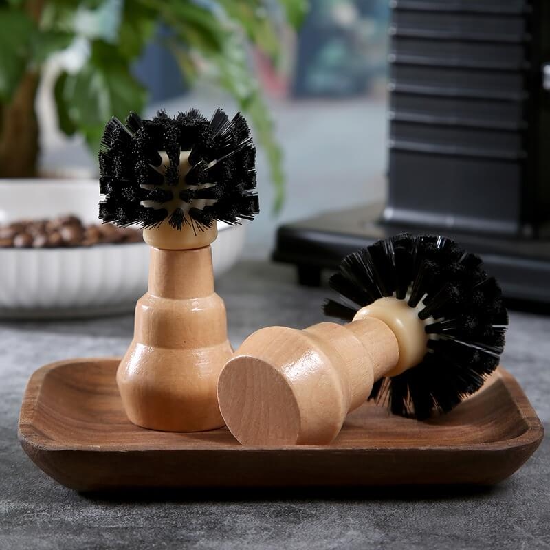 Coffee cleaning brush removing grounds from espresso portafilter