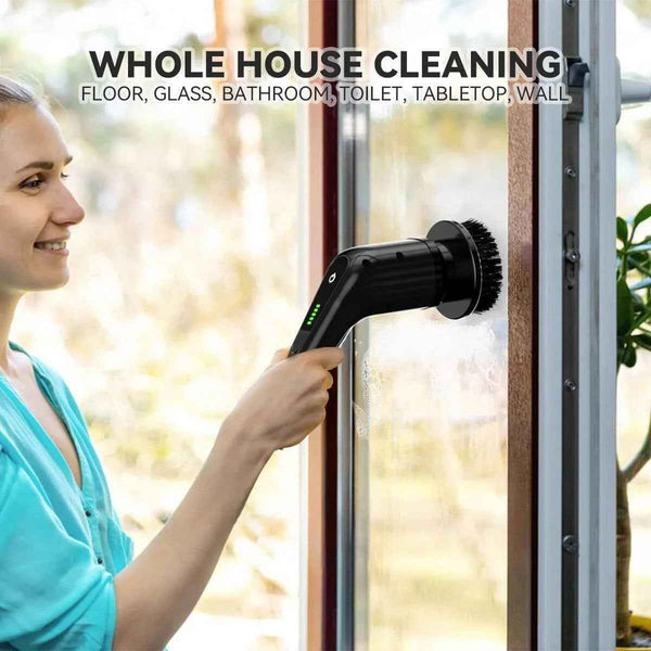 Woman using cordless electric cleaning brush to clean glass window surface for whole house cleaning including floor bathroom and wall