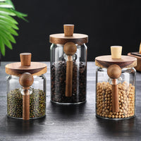 Close-up of glass storage jar showing natural wooden lid knob and matching wooden spoon