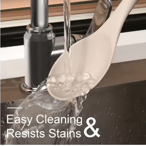 Silicone spoon rinsed under running water showing easy clean stain resistant surface