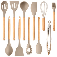 12 piece silicone cooking utensil set with wooden handles on white background