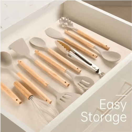 Silicone cooking utensils with wooden handles stored flat in kitchen drawer