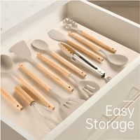 Silicone cooking utensils with wooden handles stored flat in kitchen drawer