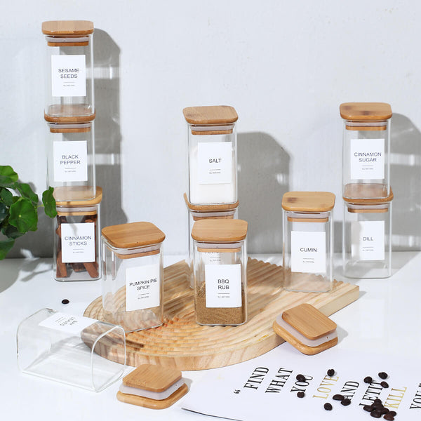 12 stacked square spice jars with labels styled on wooden tray