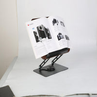 Wood book stand holding open magazine showing adjustable angle for reading