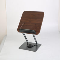 Adjustable wood book stand with walnut finish holding board and black metal frame on white background