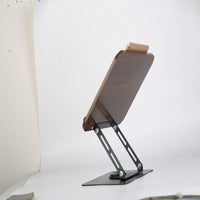 Side view of wood book stand showing adjustable arm angle with phone resting on board